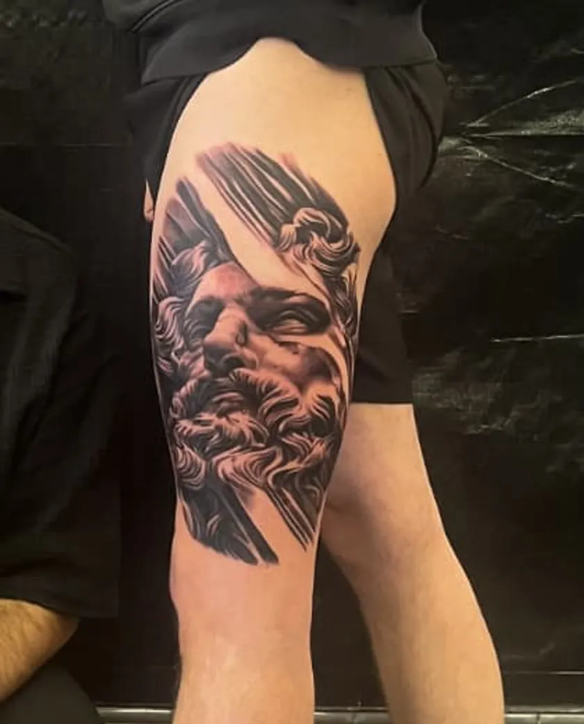 Olympian: black and grey tattoo on the thigh