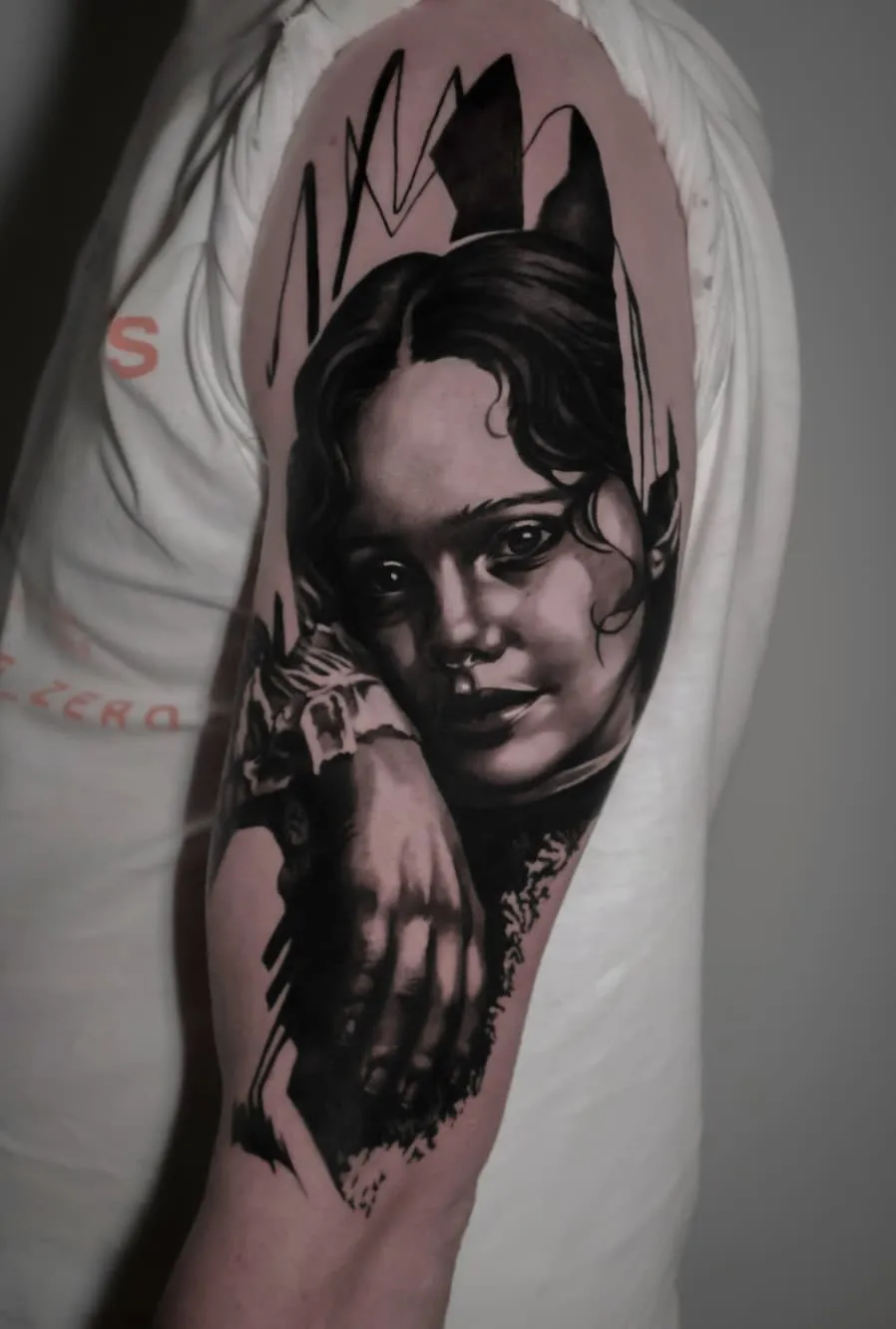 Portrait Study: black and grey tattoo on the upper arm