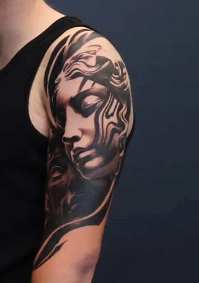 Muse: black and grey tattoo on the shoulder / upper arm